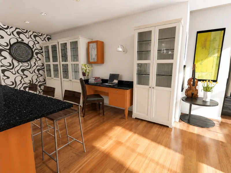 Open-plan interior with an orange kitchen island, compact matching home office, white display cabinets, patterned accent wall, and wood flooring.