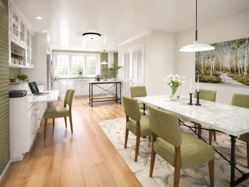 Open white kitchen and dining room with green upholstered chairs, a marble dining table, wood flooring, built-in desk, and large windows.