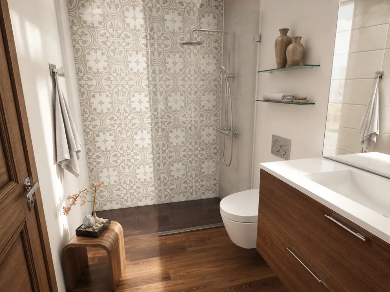 Modern bathroom with a decorative patterned shower wall, floating toilet, wood vanity, glass shelves, and warm wood flooring.