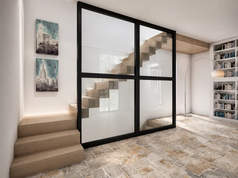 Modern wood staircase enclosed by black-framed glass, with a built-in bookcase and stone tile flooring.