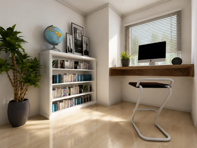 Small home office with a wood desk beneath the window, computer, white bookcase, globe, and large potted plant.