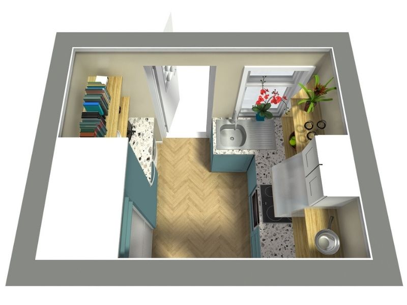 3D top-down view of a small galley kitchen with teal lower cabinets, white upper cabinets, and wood countertops. The sink is placed under a window with potted plants and red flowers. The kitchen includes a stove with a stainless steel hood, bookshelves on the left wall, and a light herringbone wood floor.