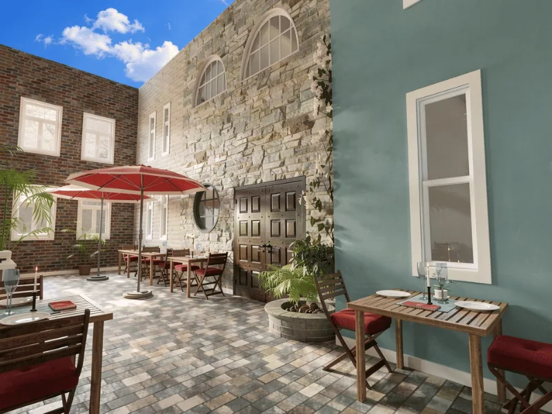 Courtyard showing arched, double-hung, and rectangular windows on brick, stone, and painted exterior walls.