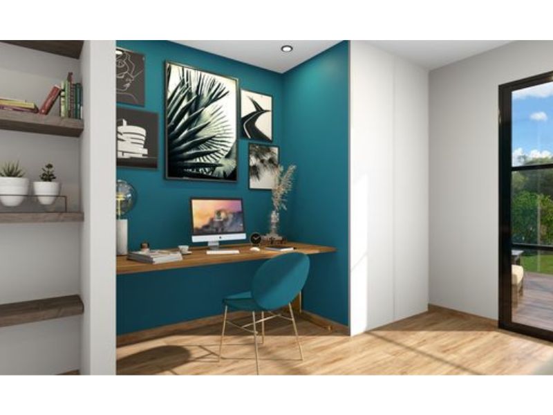 3D photo of a home office made with Cedreo. The floor plan has one desk and chair. There are photos on the wall in front of the desk that face the wall. On either side of the desk are shelving units.