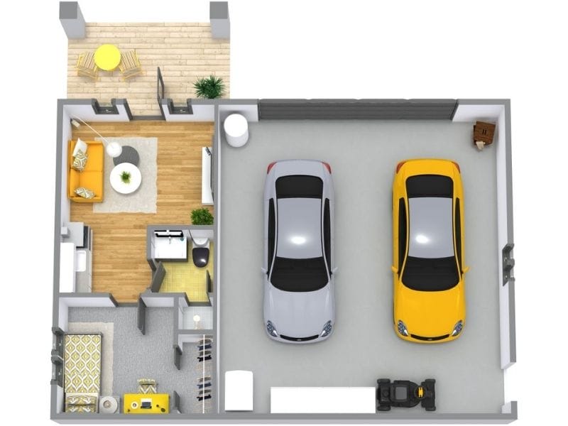 Top-down floor plan showing a home interior connected to a two-car garage, with a small front porch or patio area outside the living room featuring outdoor seating.