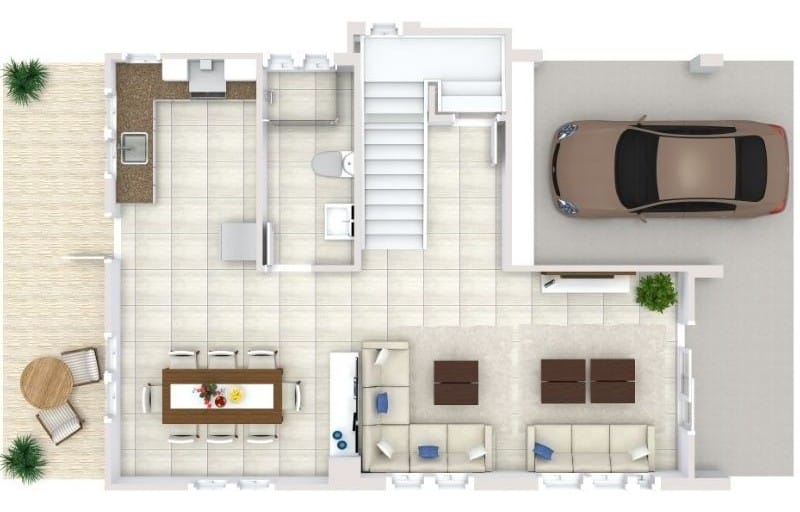 Top-down floor plan of a ground level with open living and dining areas, tiled kitchen space, stairway at the center, and an attached garage with driveway, plus a small outdoor seating area on the patio.
