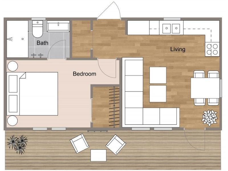2D floor plan of a one-bedroom apartment with an open living, dining, and kitchen area, a separate bedroom, bathroom, and a large outdoor deck with seating.