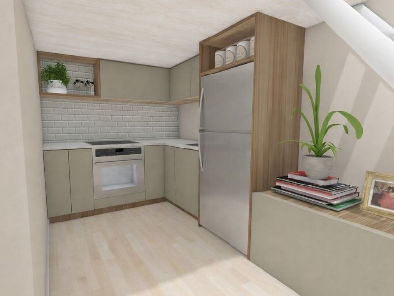 3D photo showing a modern L-shaped kitchen in a tiny house underneath a sleeping loft. The kitchen has flat green fronts and wooden frames. There's a stove, sink, tall fridge, and a storage cabinet on the floor with books, a picture, and a plant on top for decoration.
