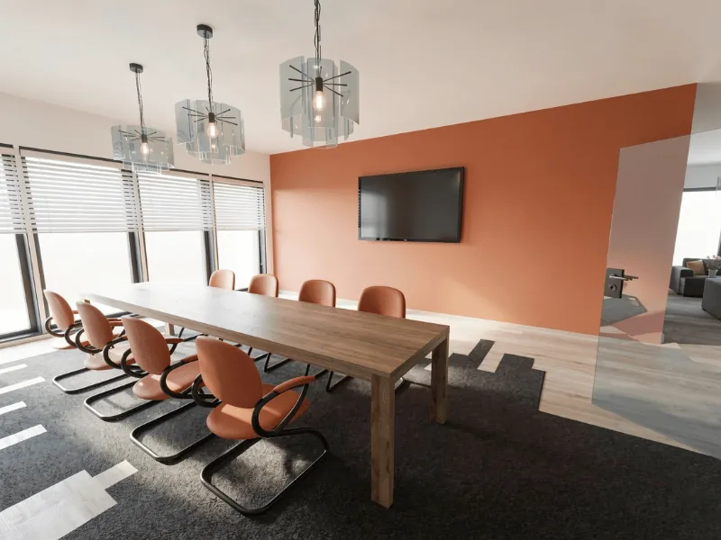 Modern conference room with a long wooden table, orange chairs, geometric pendant lights, large windows with blinds, and a wall-mounted TV on a terracotta accent wall.