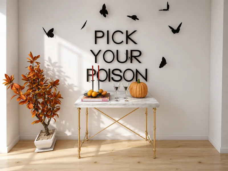Halloween-themed console display with “PICK YOUR POISON” wall lettering, black butterfly decorations, an orange-leaved plant, a pumpkin, candles, and cocktail glasses.