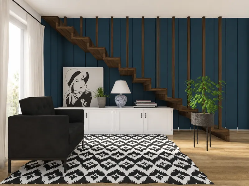 Modern sitting area with a floating wooden staircase against a navy slatted wall, black armchair, white storage cabinet, geometric black-and-white rug, plants, and monochrome portrait art.