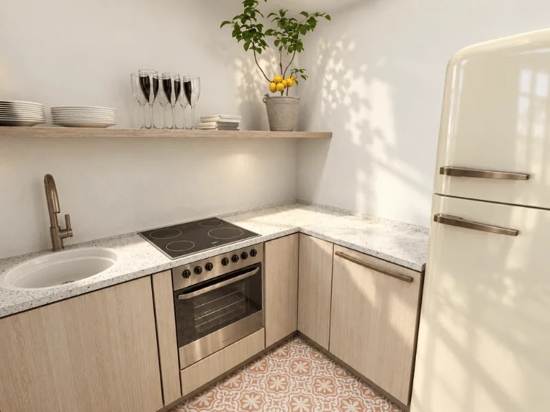Small L-shaped kitchen layout with light wood cabinets, compact appliances, and open shelving.