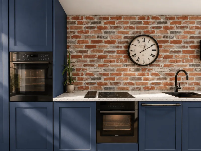 Small kitchen layout with dark blue cabinets, exposed brick backsplash, and built-in appliances.