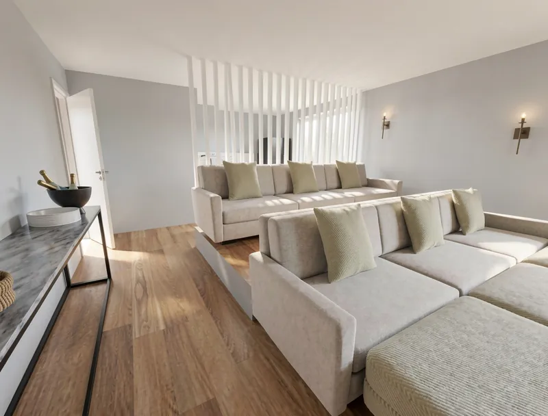 Bright lounge with two large cream sectional sofas, pale green cushions, wood flooring, minimalist wall sconces, and a slim console table with a champagne bucket.