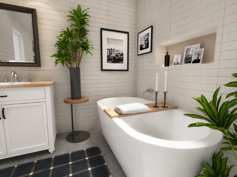 Scandinavian-style bathroom with a freestanding white bathtub, white vanity, light tiled walls, black-and-white artwork, candles, wood accents, and abundant green plants.