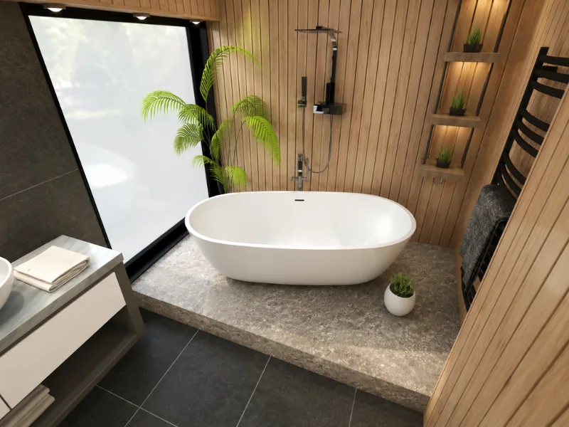Modern bathroom with a white freestanding tub on a raised stone platform, vertical wood paneling, black shower fixtures, built-in display niches, and tropical plants.
