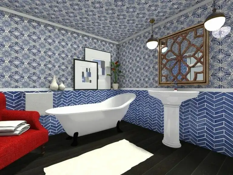 3D rendering of a bold, eclectic bathroom design featuring patterned blue and white wallpaper, a freestanding clawfoot bathtub, and a pedestal sink. The walls and ceiling are covered in intricate tile-like patterns, with a chevron design on the lower walls. A large mirror with a decorative wooden frame hangs above the sink, and a bright red armchair with towels adds a pop of color. Dark wood floors and pendant lights complete the look.