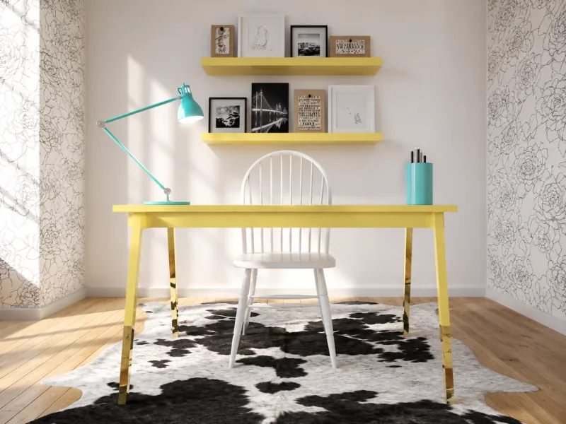 Bright home office with a yellow desk and floating shelves, turquoise task lamp, white spindle chair, framed artwork, floral wallpaper, and a black-and-white cowhide rug.