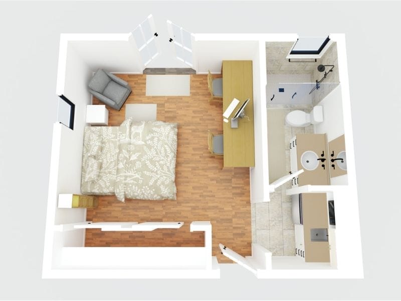 CubiCasa 3D floor plan of a hotel room. The room features a double bed, a desk with a computer on top of it, a grey chair in the corner of the room, and two nightstands on each side of the bed. There is also a small kitchen area with a sink and a fridge, as well as a bathroom with a toilet, vanity, and a shower.