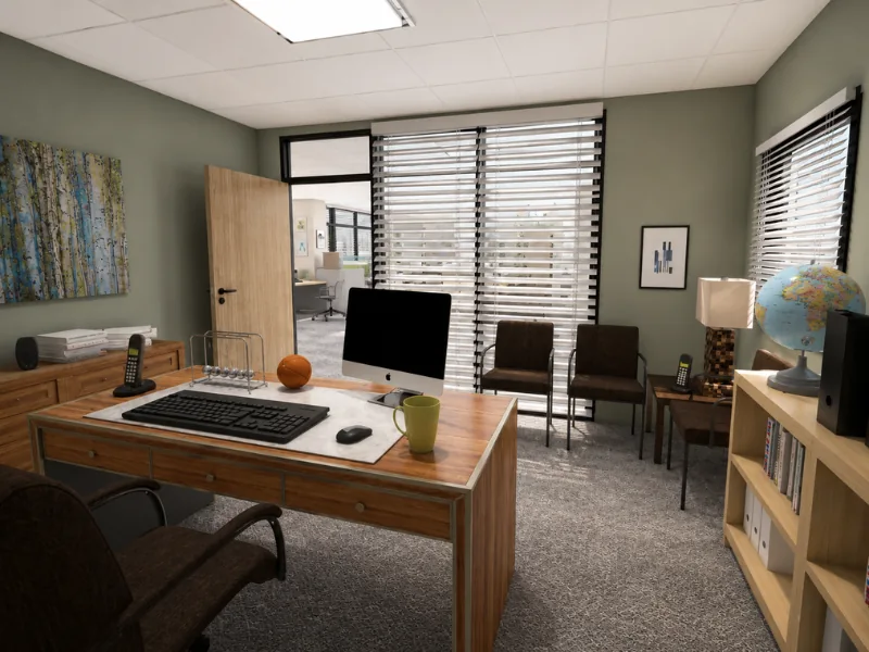 Michael Scott’s office at Dunder Mifflin, featuring his wood desk, desktop computer, guest chairs, globe, storage cabinets, green walls, and horizontal blinds.