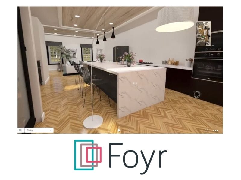The image shows a screenshot from a Foyr Neo 360 walkthrough of a kitchen with a marble kitchen island with seating. The kitchen counters have a black front with white counter tops.