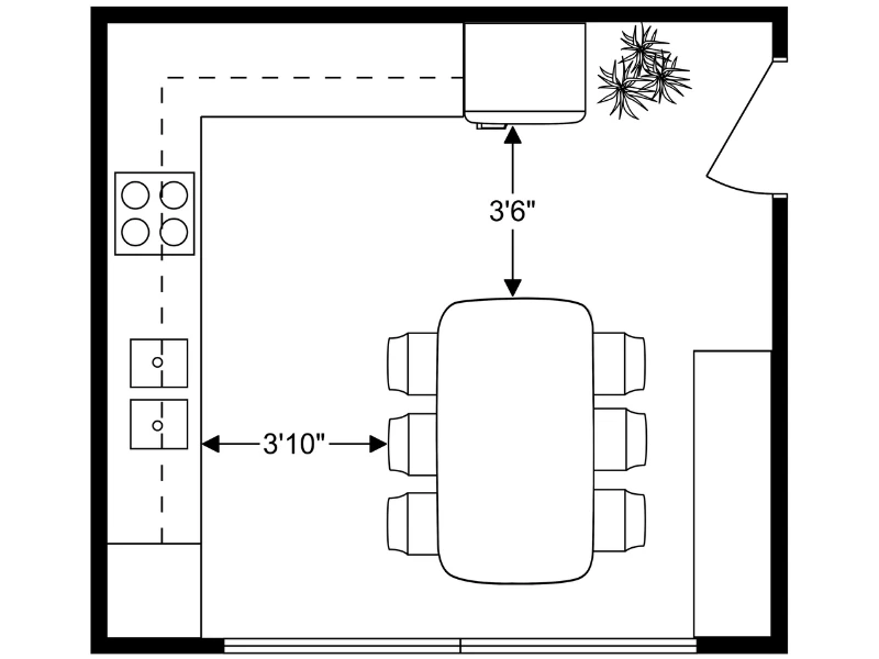 A simple kitchen floor plan showing an L-shaped counter with a stove, a double sink, and lower cabinets along two walls. A rectangular dining table with six chairs is positioned in the center of the room. Measurements indicate 3 feet 10 inches of space between the table and counter, and 3 feet 6 inches between the table and a corner bench with a small plant nearby. A door opens into the room from the right side.