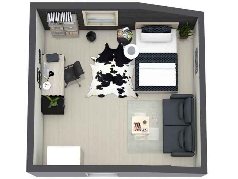 3D floor plan of a modern teenage bedroom with a bed along the top wall, a desk and chair with a computer on the left, and a dark sofa with a coffee table on the right. The room features light wood flooring, a black-and-white cowhide rug in the center, bookshelves by the window, and plants for decoration.