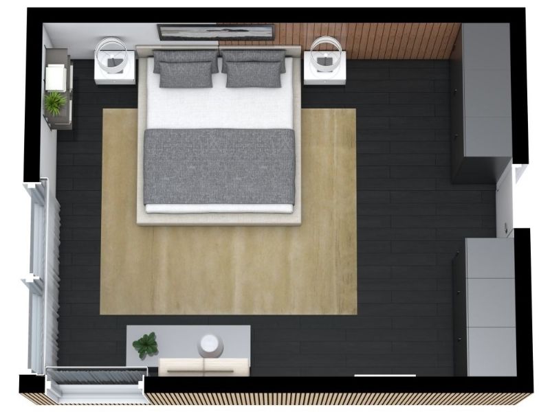 3D floor plan of a modern bedroom with a large double bed centered against the top wall, flanked by two white nightstands. The room features dark wood flooring with a large beige area rug, built-in wardrobes on the right, and a small sofa with a round table near the bottom window.
