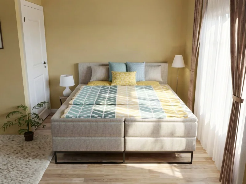 Small bedroom with a king sized bed and one side table.