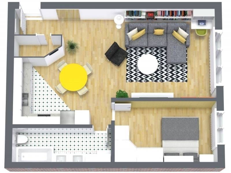 3D floor plan of a one-bedroom apartment with an open layout. The living room features a large gray sectional sofa, patterned rug, round coffee table, and bookshelves.