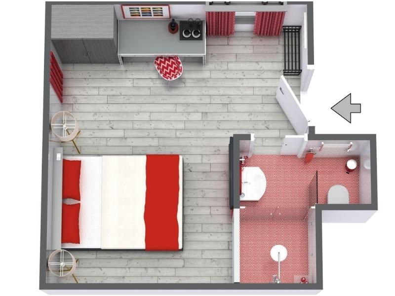3D floor plan of a modern hotel room with a double bed, two small round bedside tables, and a desk with a chair. The adjoining bathroom features red floor and wall tiles, a bathtub, a toilet, a sink, and a shower.