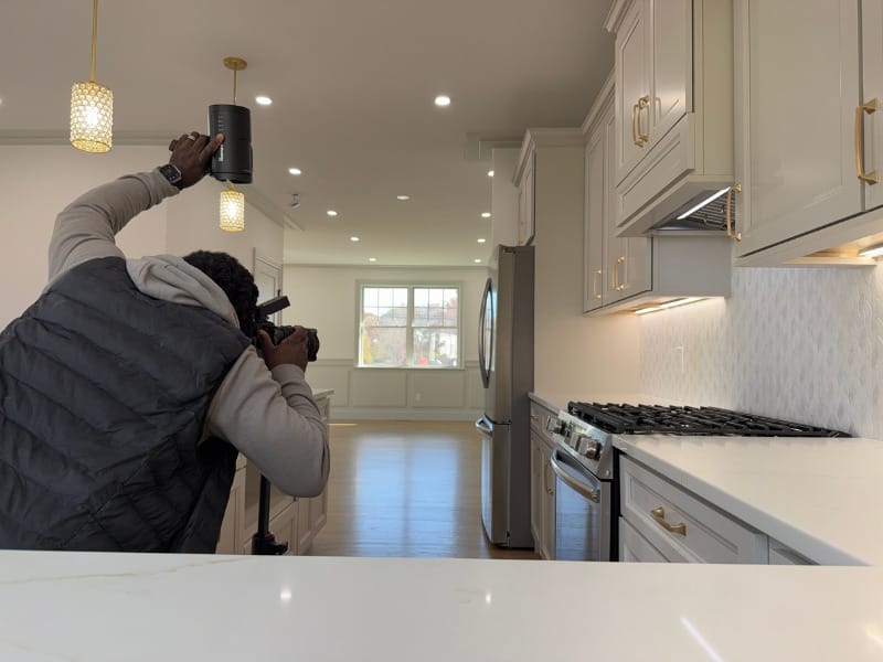 Real estate photographer Roamy Fils-Aime at work photographing a house.